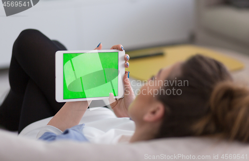 Image of woman on sofa using tablet computer