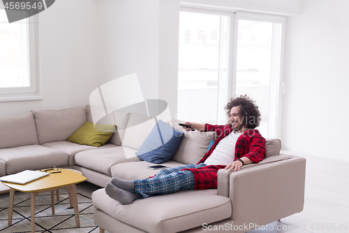 Image of young man in bathrobe enjoying free time