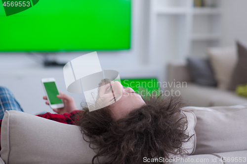 Image of young man in bathrobe enjoying free time