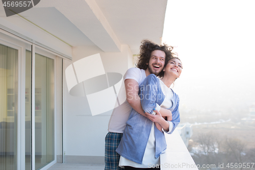 Image of Couple hugging on the balcony