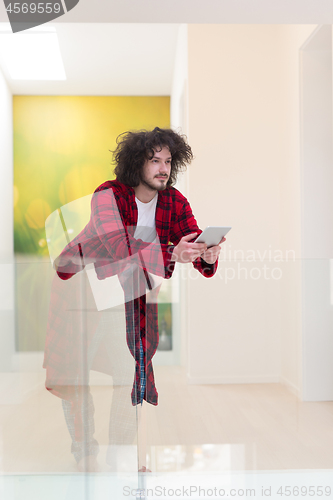 Image of young freelancer using tablet computer