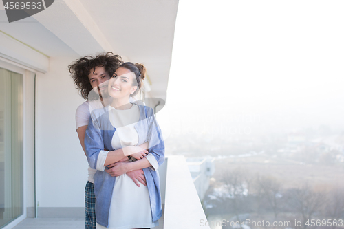 Image of Couple hugging on the balcony