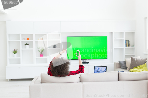 Image of young man in bathrobe enjoying free time