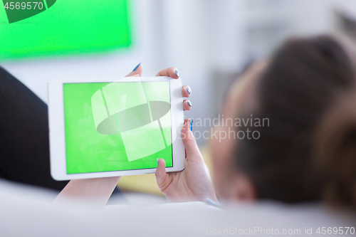 Image of woman on sofa using tablet computer