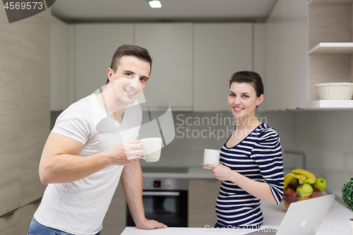 Image of couple with laptop computer enjoying morning