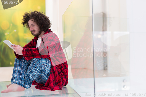 Image of young freelancer using tablet computer