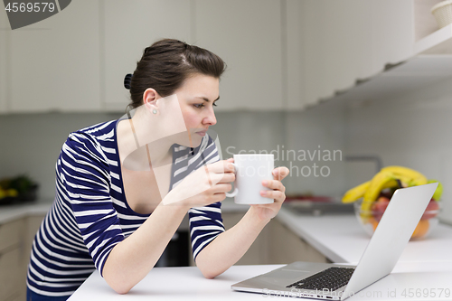 Image of woman drinking coffee enjoying relaxing lifestyle