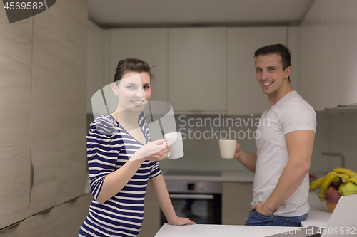 Image of couple with laptop computer enjoying morning