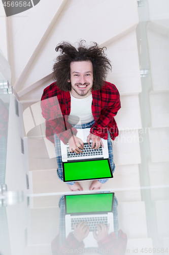 Image of freelancer in bathrobe working from home