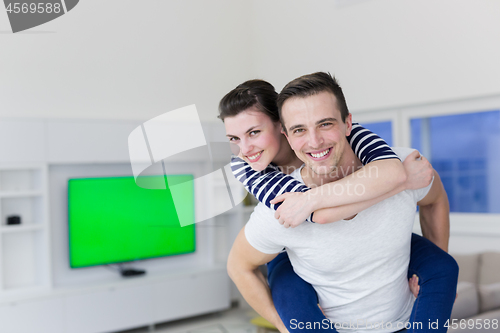 Image of handsome man piggybacking his girlfriend