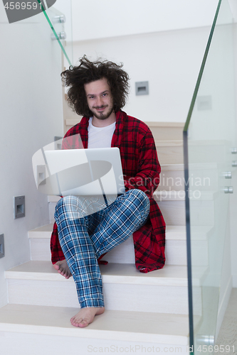 Image of freelancer in bathrobe working from home