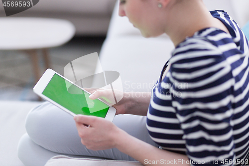 Image of woman on sofa using tablet computer