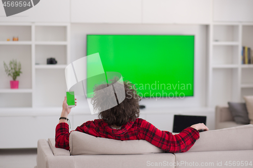 Image of young man in bathrobe enjoying free time