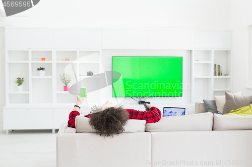 Image of young man in bathrobe enjoying free time