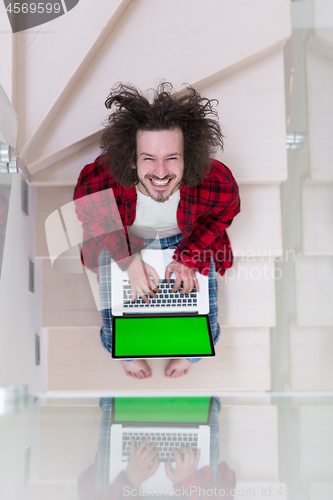 Image of freelancer in bathrobe working from home