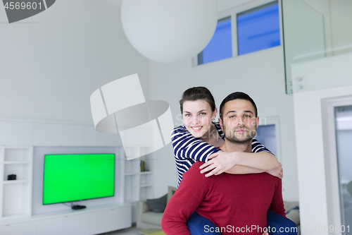 Image of handsome man piggybacking his girlfriend