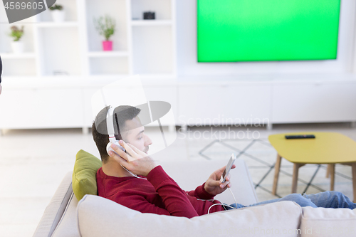 Image of man enjoying music through headphones