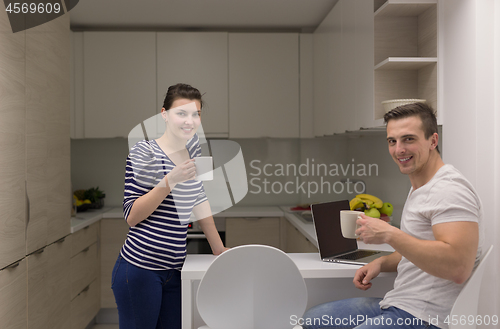 Image of couple with laptop computer enjoying morning