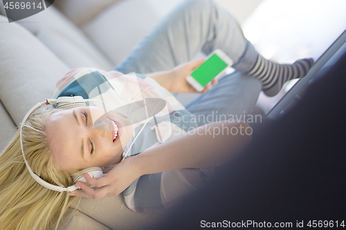 Image of girl enjoying music through headphones