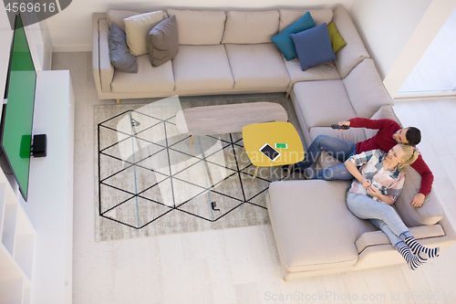 Image of Young couple on the sofa watching television