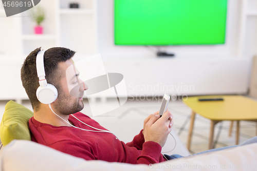 Image of man enjoying music through headphones