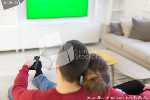 Image of Young couple on the sofa watching television