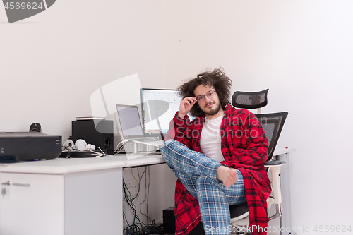 Image of graphic designer in bathrobe working at home