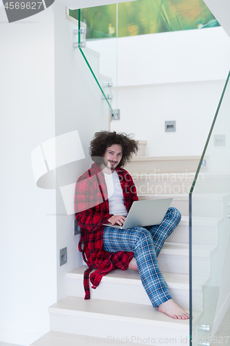 Image of freelancer in bathrobe working from home