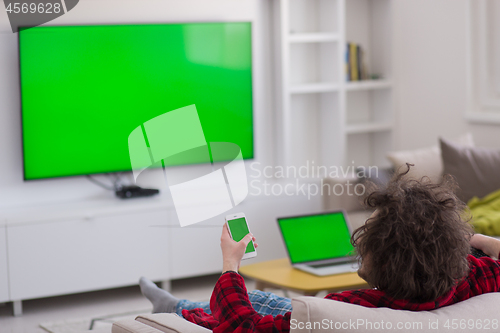 Image of young man in bathrobe enjoying free time