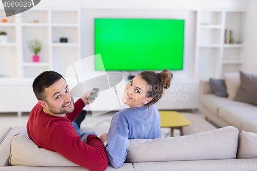 Image of Young couple on the sofa watching television