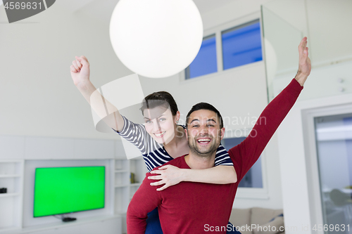 Image of handsome man piggybacking his girlfriend