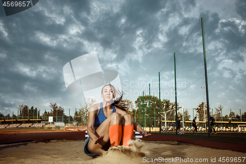 Image of Female athlete performing a long jump during a competition