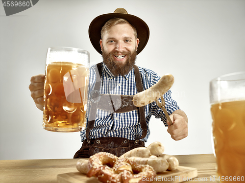 Image of Germany, Bavaria, Upper Bavaria, man with beer dressed in tradit