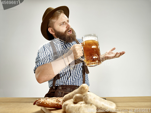 Image of Germany, Bavaria, Upper Bavaria, man with beer dressed in tradit