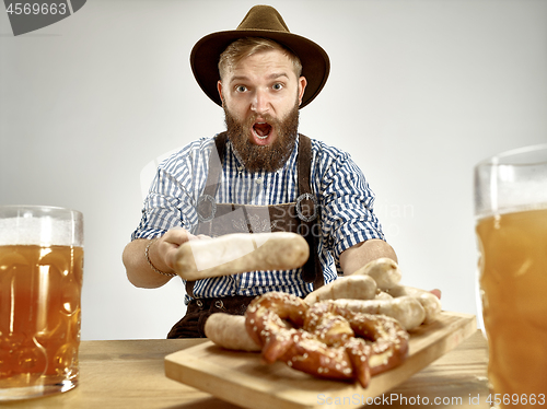 Image of Germany, Bavaria, Upper Bavaria, man with beer dressed in traditional Austrian or Bavarian costume