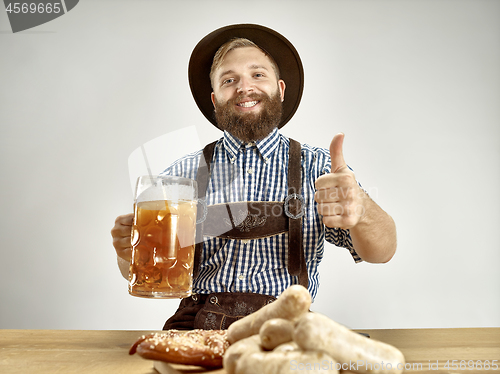 Image of Germany, Bavaria, Upper Bavaria, man with beer dressed in traditional Austrian or Bavarian costume