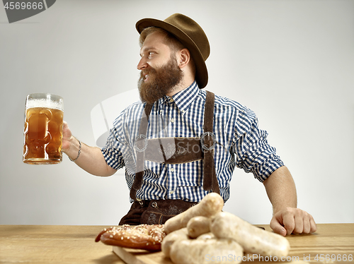 Image of Germany, Bavaria, Upper Bavaria, man with beer dressed in tradit