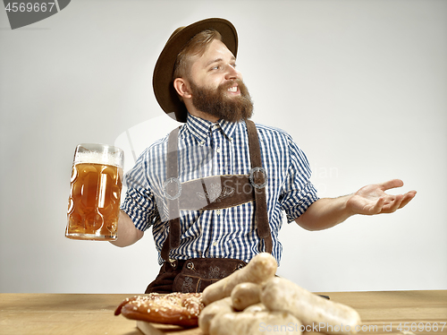 Image of Germany, Bavaria, Upper Bavaria, man with beer dressed in tradit