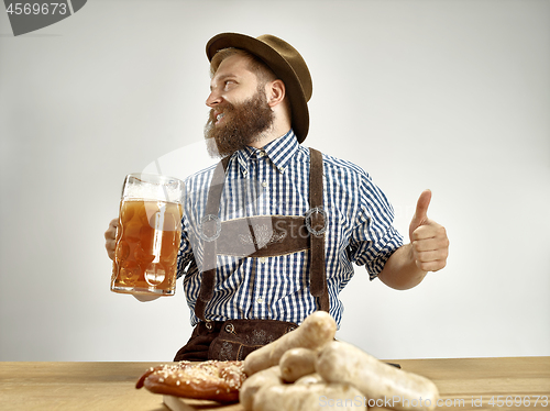 Image of Germany, Bavaria, Upper Bavaria, man with beer dressed in traditional Austrian or Bavarian costume