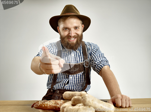 Image of Germany, Bavaria, Upper Bavaria, man with beer dressed in traditional Austrian or Bavarian costume