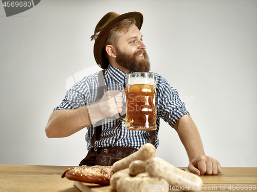 Image of Germany, Bavaria, Upper Bavaria, man with beer dressed in traditional Austrian or Bavarian costume