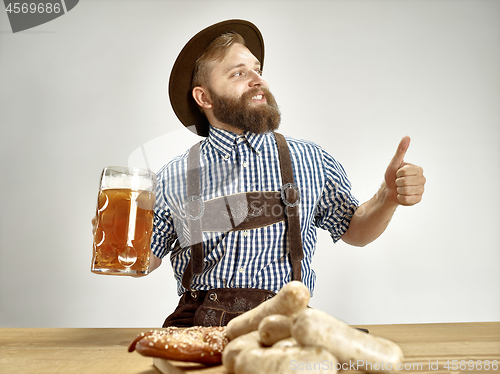 Image of Germany, Bavaria, Upper Bavaria, man with beer dressed in traditional Austrian or Bavarian costume