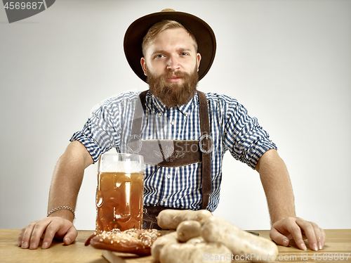 Image of Germany, Bavaria, Upper Bavaria, man with beer dressed in traditional Austrian or Bavarian costume