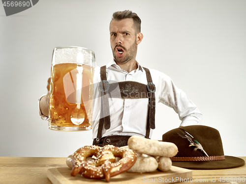 Image of Germany, Bavaria, Upper Bavaria, man with beer dressed in traditional Austrian or Bavarian costume