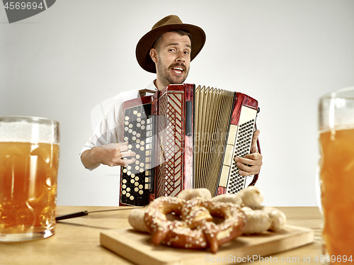 Image of Man in traditional bavarian clothes playing accordion. Oktoberfest