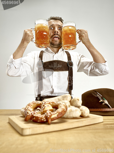 Image of Germany, Bavaria, Upper Bavaria, man with beer dressed in traditional Austrian or Bavarian costume