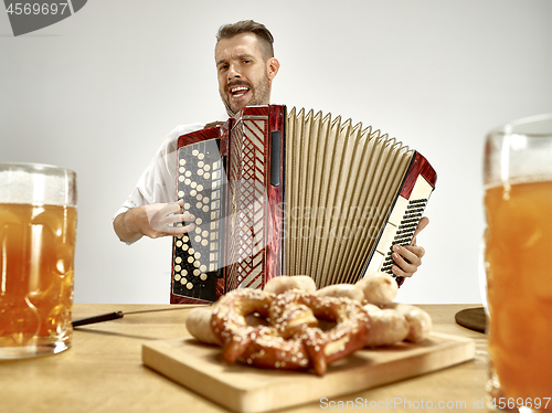 Image of Man in traditional bavarian clothes playing accordion. Oktoberfest