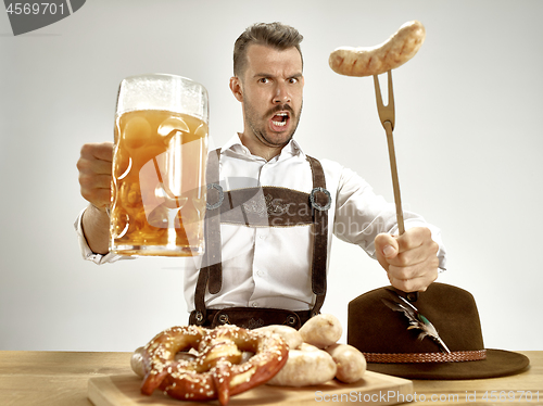 Image of Germany, Bavaria, Upper Bavaria, man with beer dressed in traditional Austrian or Bavarian costume