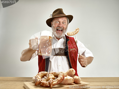 Image of Germany, Bavaria, Upper Bavaria, man with beer dressed in traditional Austrian or Bavarian costume