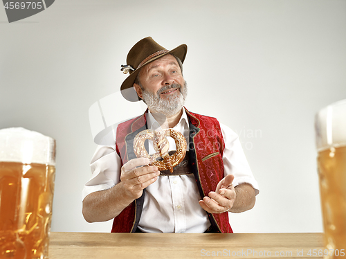 Image of Germany, Bavaria, Upper Bavaria, man with beer dressed in traditional Austrian or Bavarian costume